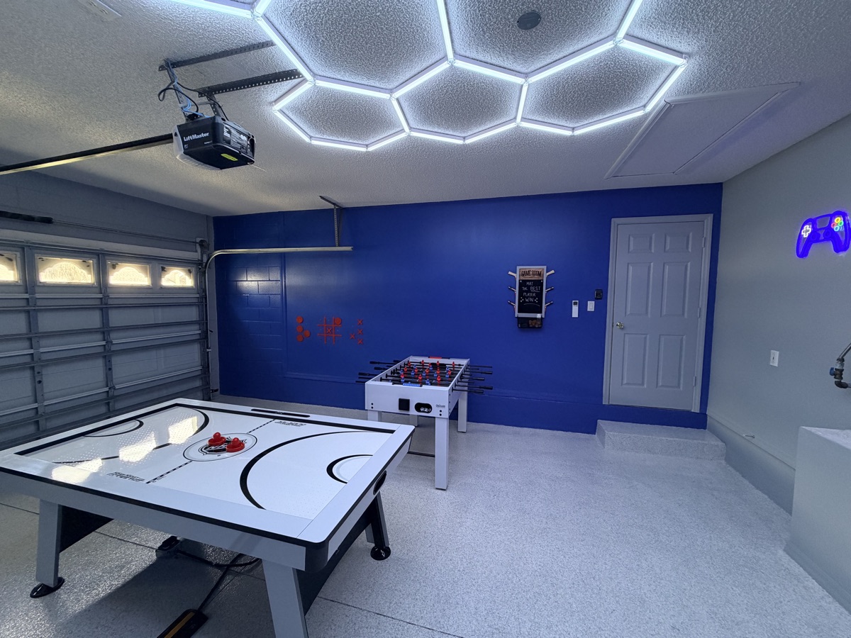 Castle Keys climate-controlled garage game room with air hockey, foosball, and LED ceiling